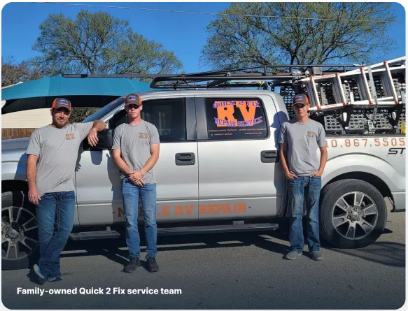 Three certified Quick 2 Fix technicians standing in front of their silver mobile service truck with ladder rack in Abilene.